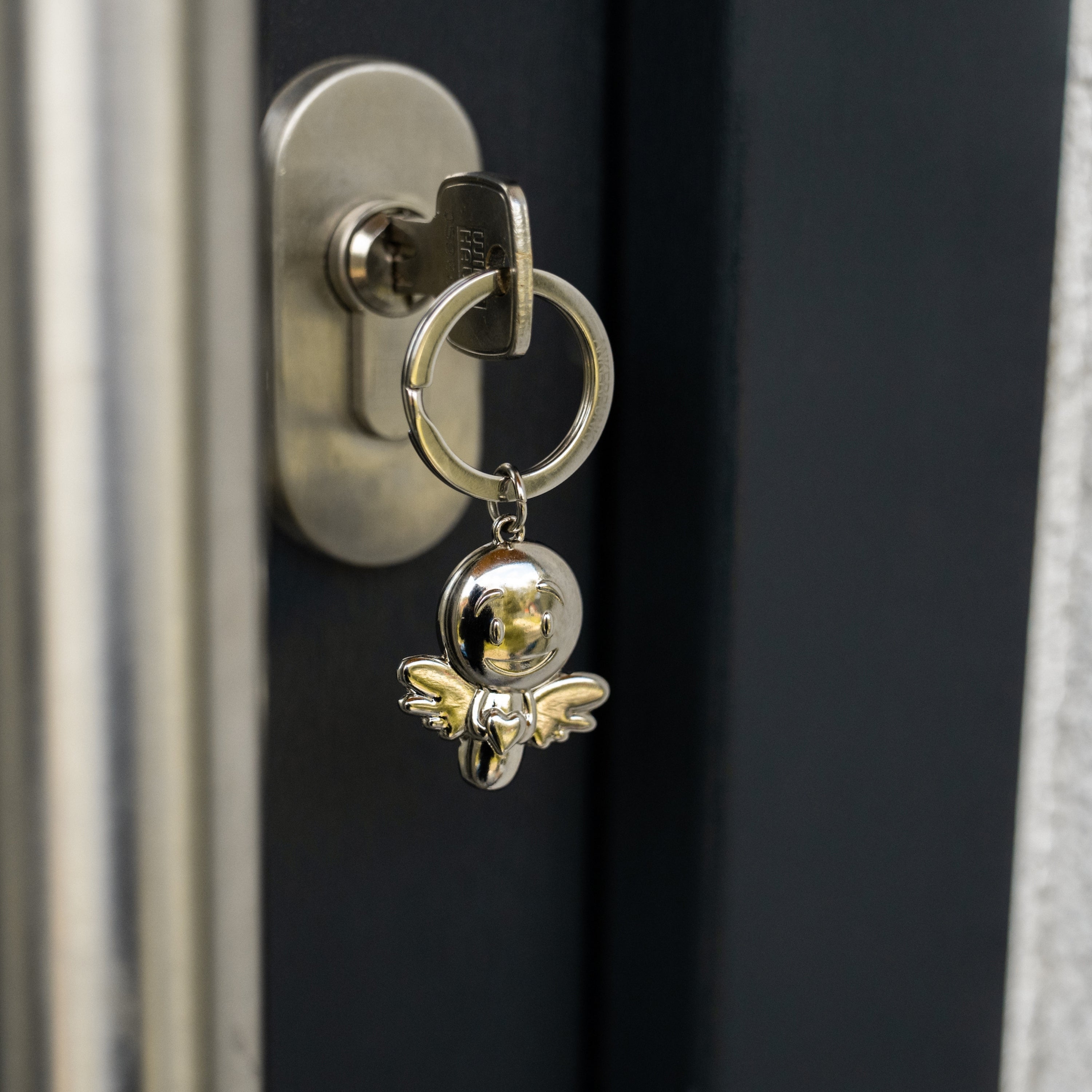 Schlüsselanhänger Lovely silber glänzend im Türschloss hängend